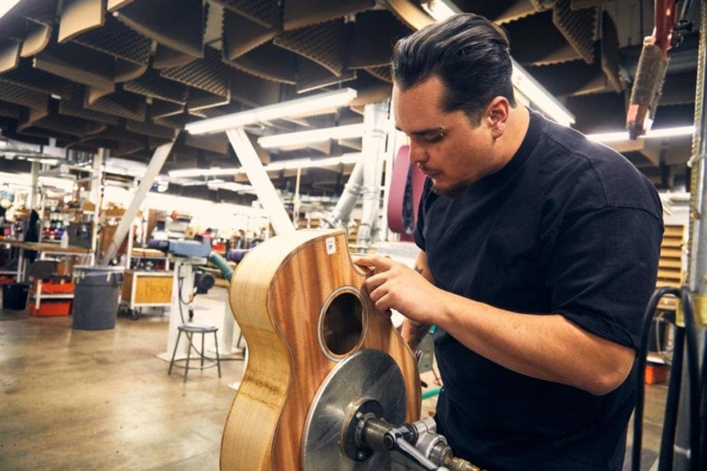 Clinton Jackson of Taylor Guitars works on a guitar made out of a new urban-sourced wood.