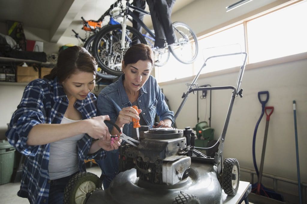 mother-daughter fixing lawn mower