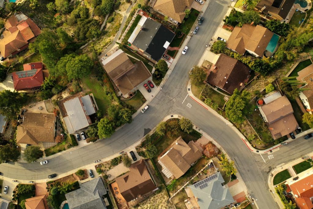 Top down view of Los Angeles Suburb, La Canada, looking down at rooftops, pools, backyards, streets and neighborhoods.