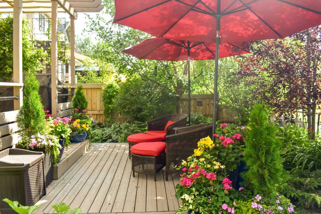 Outdoor deck in urban oasis garden in summer sunshine